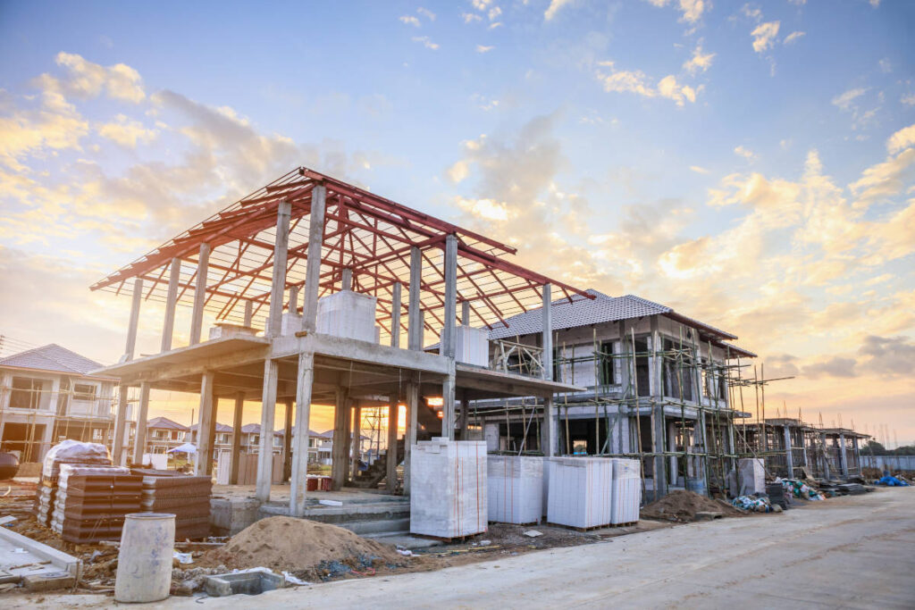 Image of a house being built, with scaffolding surrounding, to illustrate how long it might take to build a house